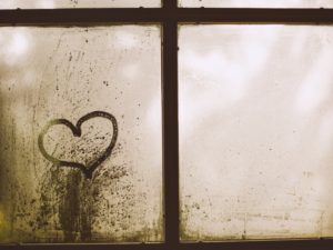Heart drawn on a foggy window
