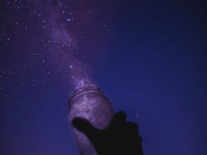 Holding glass jar with stars