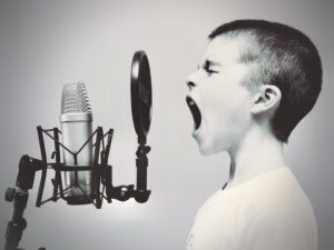 Boy singing on a microphone; Parry sound, Canada