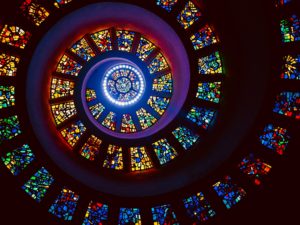 A spiralling stained glass window inside a chapel at Thanks-Giving Square in Dallas; TX, USA